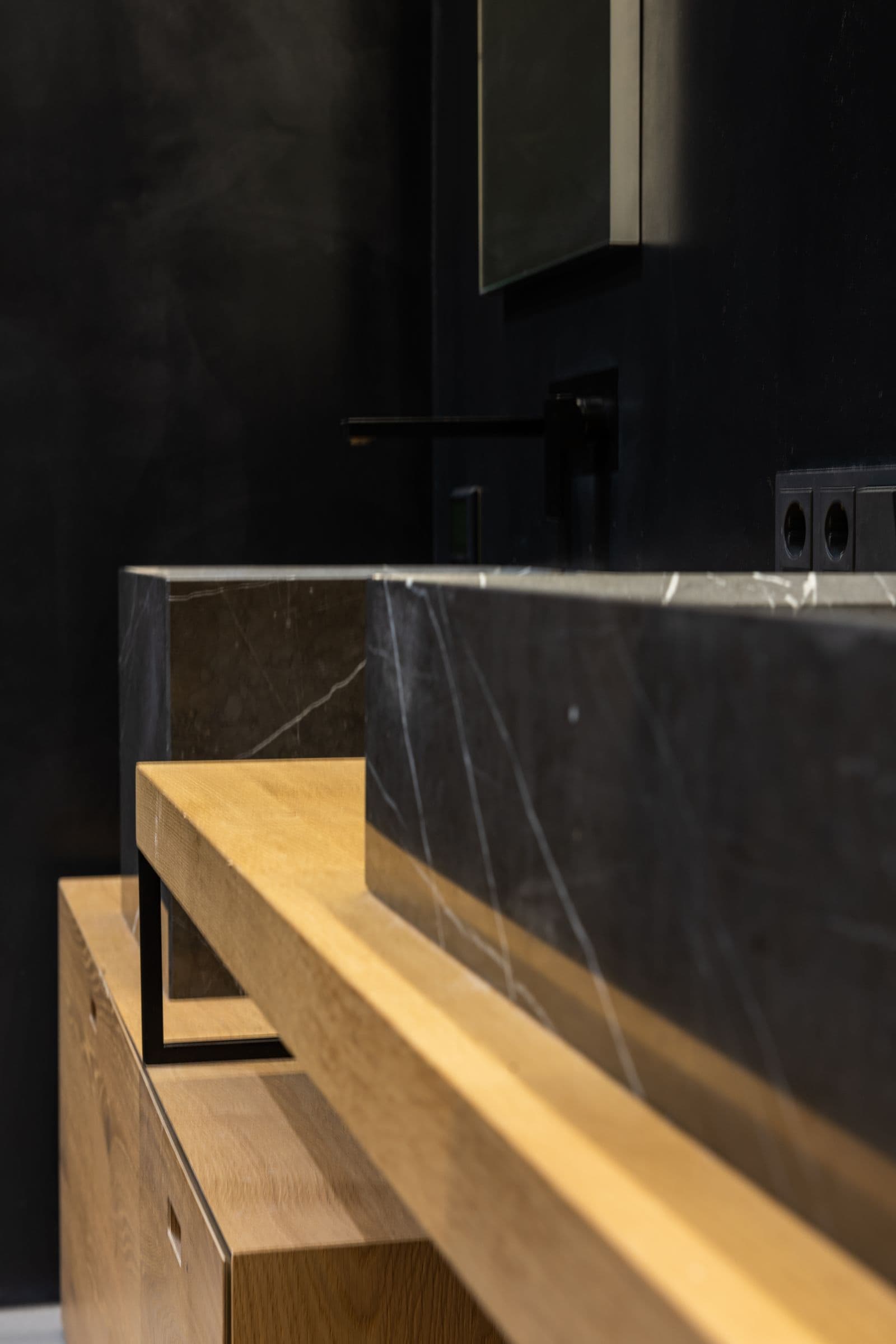 Black veined stone vanity trough with oak cabinetry